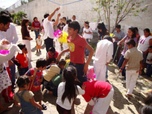 Social workers at the Oaxaca State Prison facilitated a baptism ceremony for inmates' children officiated by the prison chaplain, Reverend Spencer Thompson, Afterward, prosoners, their families and visitors enjoyed piñatas. Maintaning strong family ties helps prisoners adapt better upon their release. © John McClelland, 2010