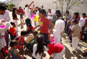 Social workers at the Oaxaca State Prison facilitated a baptism ceremony for inmates' children officiated by the prison chaplain, Reverend Spencer Thompson, Afterward, prosoners, their families and visitors enjoyed piñatas. Maintaning strong family ties helps prisoners adapt better upon their release. © John McClelland, 2010