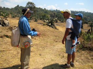 Don Jose, an experienced tlachiquero, coverses with the author's husband in the maguey field. In Mexico, pulque is fermented from the sap of the maguey. © Julia Taylor, 2010