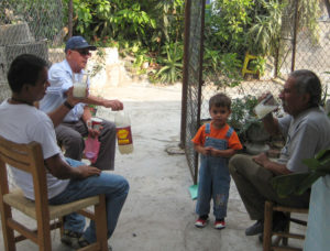 We have too much pulque for my husband and he does what any good Mexican would do. He tells our nearest neighbors that he has some pulque to share.The men sit in the shade, chatting and sipping their glasses of cold pulque, relaxing while strengthening the social bonds that make Mexican society strong. © Julia Taylor, 2010