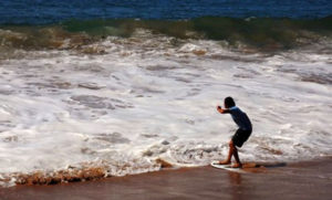 Gentle surf attracts this young skimboarded on Melaque beach in Mexico. © Gerry Soroka, 2010