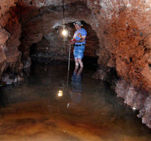 A speleologist surveys Amatitan's qanat, or underground aqueduct, which was found to have 113 meters of passages. Amatitan may have been the birthplace of tequila. © John Pint, 2010