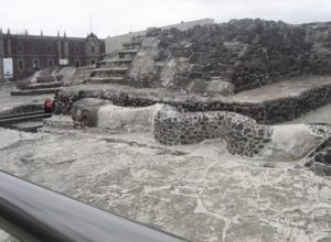 A serpent sculpture slithers across the plaza in front of the ancient Aztec Templo Mayor in downtown Mexico City © Raphael Wall, 2014