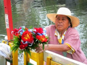 A woman sells roses on the canals of Xochimilco, Mexico, where many a young man courts his sweetheart © Edythe Anstey Hanen, 2013