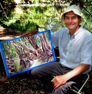 Mexican artist Jorge Monroy with his just-completed painting of the Bald Cypress trees along El Río de Los Sabinos, nine kilometers north of Lake Chapala.Mex © John Pint, 2011