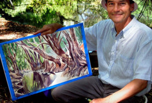 Mexican artist Jorge Monroy with his just-completed painting of the Bald Cypress trees along El Río de Los Sabinos, nine kilometers north of Lake Chapala.Mex © John Pint, 2011