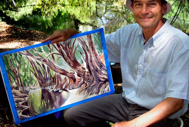 Mexican artist Jorge Monroy with his just-completed painting of the Bald Cypress trees along El Río de Los Sabinos, nine kilometers north of Lake Chapala.Mex © John Pint, 2011