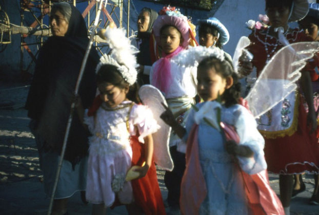 Little girls dress as angels in this photograph from the 1960s. Along the streets, townspeople watch the annual Good Friday pageantry and processions in San Miguel de Allende, Mexico. © Don Fyfe Wilson, 1964, 2010