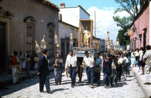 Beautiful religious images, lovingly crafted by skilled santeros, are reverently carried through the streets of San Miguel de Allende, Mexico in the 1960s. These processions are part of the annual Good Friday observances. © Don Fyfe Wilson, 1964, 2010