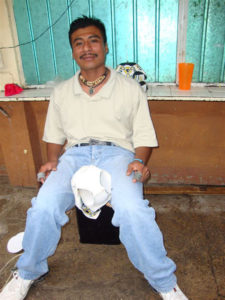 One cannot help but be impressed by the industriousness of most inmates in the Oaxaca State Prison. If they are to enjoy any supplements to their meager existence, they need to make money and so they sit hour after hour at their chosen profession. This young man stitshes soccer balls. © John McClelland, 2010