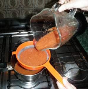 Strain the salsa into a small saucepan and cook over low heat. © Daniel Wheeler, 2010