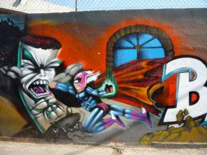 The outer walls of a Mexico City school dispay sanctioned wall art, in this case, an elaborate super hero scene. © Anthony Wright, 2009