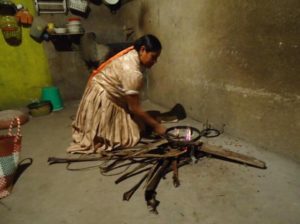 Gloria Cruz is in the kitchen at 4:25 a.m. starting a fire using dried agave leaves. She will prepare tejate to sell at the Sunday market. © Alvin Starkman, 2012