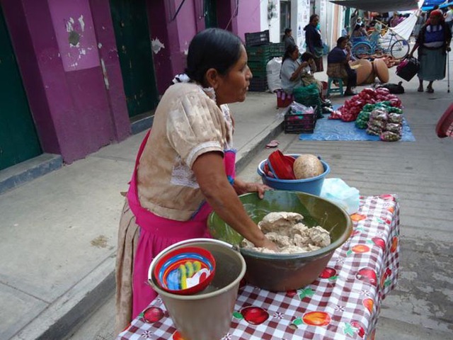 Gloria kneads the ground ingredients for tejate a final time at the market before ading the water to create a beverage. © Alvin Starkman, 2012