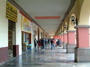 Portales are almost everywhere in Toluca. Here looking south on the east side of Bravo street from near Independencia street your 10 peso McDonald's hamburger is ahead at the corner.