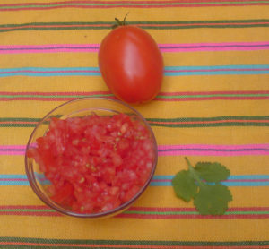 Chopped tomato is not a typical ingredient in guacamole. Yet it adds a nice flavor and color, combining with white onion and green avocado, chile and cilantro to echo the colors in the Mexican flag. © Daniel Wheeler, 2009