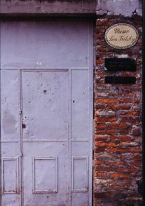 Bullet holes scar the steel front door of Trotsky's house in Coyoacán.Photography by John Mitchell. © 2001