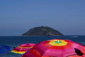 Colorful umbrellas planted in the sand spring up on the beaches of Jaltemba Bay during the Easter holidays in Mexico. © Christina Stobbs, 2011