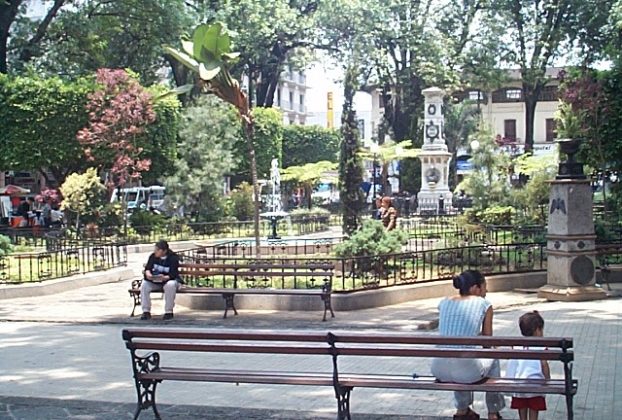 One of the fountains with benches and trees for shade.