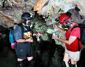 Researchers Diana Northup and Penny Boston sample sulfur from a hydrogen sulfide spring near the Chiribltil Passage near the entrance to Sala Grande, Cueva de la Villa Luz. This cave in Mexico's state fo Tabasaco is also known as Las Sardinas. © Ken Ingham, 2010
