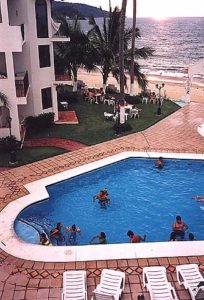 The last rays of the late afternoon sun illuminate the pool area of Villas Buena Vida. © Gwen Burton, 2001