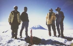 The author Richard Ferguson, with Chip, Chris and Bruce, on the flat summit of Iztata, with Popo in the background.© Richard Ferguson