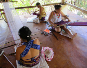 Working together, Mexican women weavers enjoy one another's company as they create colorful textiles. They are members of the Tixinda women's cooperative in Pinotepa de Don Luis, Oaxaca. © Geri Anderson, 2011