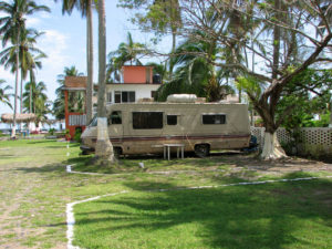 ''Wild Bill,'' a retiree from the US, lives full time in his RV beneath the palm trees. The seventy-six year-old expatriate has chosen Mexico's Emerald Coast of Veracruz, where he calls the Quinta Alicia Trailer Park home. © William B. Kaliher, 2010
