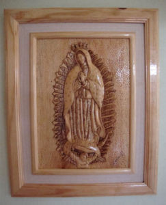 This bas-relief portrait of Our Lady of Guadalupe was carved by an artisan in the Oaxaca State Prison. This man has had to rely on his own wits to survive. He has no family in the area and has never had a personal visit during his ten years of imprisonment. His profession is now his sole means of surviving economically and mentally. © John McClelland, 2010