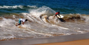 Skimboard aficionados compete in the shallow surf. Melaque beach on Mexico's Pacific coast is a favorite with the skimboard crowd. © Gerry Soroka, 2010