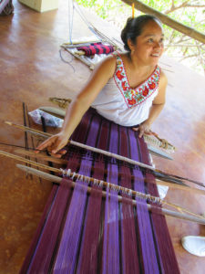 A weaver from Oaxaca, Mexico creates textile magic on the backstrap loom. © Geri Anderson, 2011