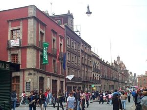 A block east on Calle Moneda. Since this street dead ends at the zocalo, it is virtually a pedestrian walkway. The lower white flag marks the entrance to the Hostel Moneda