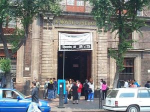 The entrance to the National Monte de Piedad, the country's pawn shop (looking west from the cathedral). It is chock full of jewelry (and guards).