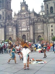 Looking north at the Cathedral Metropolitana, they are dancing around sacred objects of their faith. The cathedral is gradually sinking unevenly into the soft soil here.