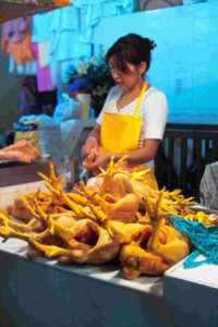 A women offers chickens for sale in a Oaxaca city market. © Dan Ellsworth, 2009