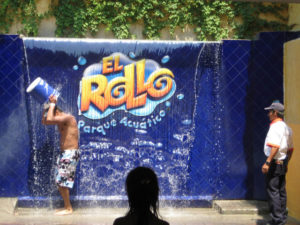 Showing off for the girl in the foreground, a boy dumps a bucket of water on his head. El Rollo Parque Acuático in Morelos, Mexico is all about fun. © Julia Taylor, 2008