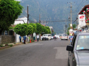 A traffic officer directs traffic off of the main street of Tepoztlan, making Sunday a day for pedestrians. Basalt mountains provide a dramatic backdrop to the town. © Julia Taylor 2007