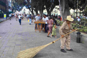 A gentleman sweeps the zócalo to the music of a marimba. © Dan Ellsworth, 2009