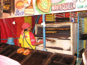 A baker prepares sweet bread in a mobile oven. © Julia Taylor, 2007