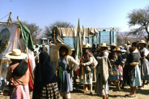 Belongings and tarpaulins are put on a truck leaving the people free to walk. The group gets under way again before the blistering sun comes up.