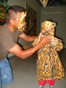 A father and son enjoy an interactive exposition at Muros. The masks and costumes depict characters from Mexican artist Diego Rivera's mural. © Julia Taylor 2008