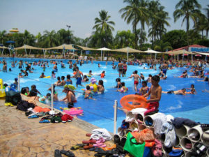 Sandals and T-shirts wait patiently outside the popular wave pool with its soft bottom at El Rollo Water Park. This is one of the most popular rides in Mexico. © Julia Taylor, 2008