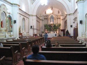 A few people take a moment for prayer before mass in the church in Santa Maria, Mexico. © Julia Taylor, 2007