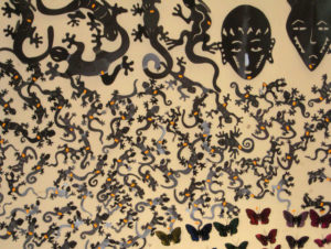 Geckos galore populate one wall of this metalwork shop. Along with an assortment of butterflies and primitive style masks, they all bear bright price stickers. These are cut out of sheet metal and hammered into low relief shapes to hang on the wall. © Julia Taylor, 2008