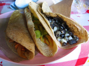 Quesadillas are folded around savory fillings. From left to right are a dish of shredded, boneless chicken, colorful flor de calabaza or chopped sauteed squash blossoms, and huitlacoche, a highly prized seasonal corn fungus. © Julia Taylor 2007