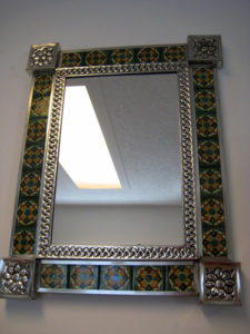 This handmade wall mirror is crafted of punched tin and decorated with ceramic. It was found at Los Espejos Artesanías Mexicanas on Calle Aguascalientes #21. © Julia Taylor, 2008