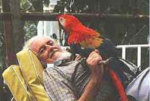 James and pet macaw relax at home. Of his constant bird companions he once said, "I am turning into a parrot."
