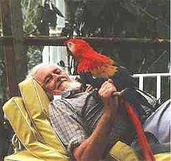 James and pet macaw relax at home. Of his constant bird companions he once said, "I am turning into a parrot."