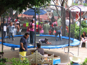 Children jump on a trampoline in the zocalo where 10 pesos buys 15 minutes of fun. © Julia Taylor, 2007