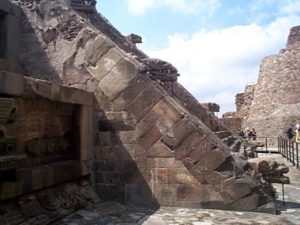 Looking back south between the temple structures is another example of the architectural detail on the stairs of main structure. The metal bars have been added to prevent collapse of the heavy carved heads.